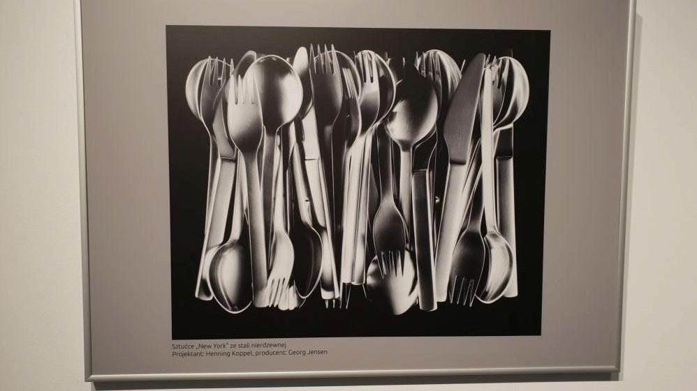 Black and white photo of a picture hanging on the wall presenting cutlery