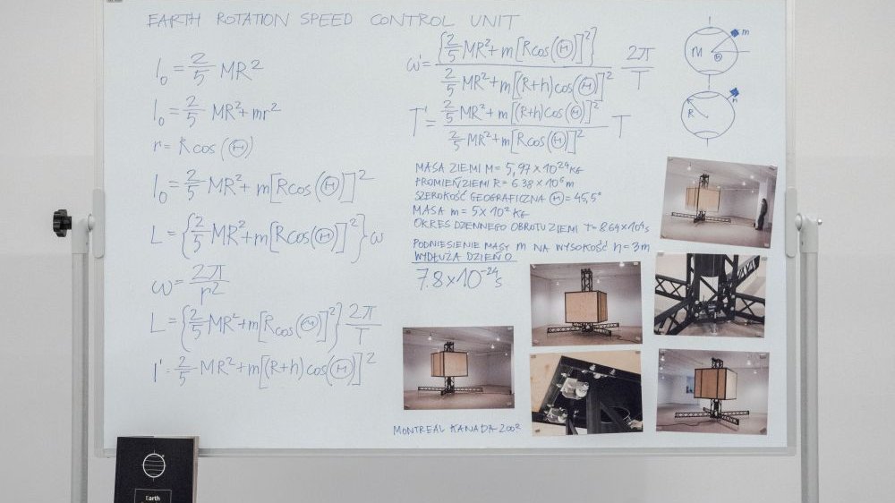 Picture of a whiteboard with some mathematical calculations and photos.