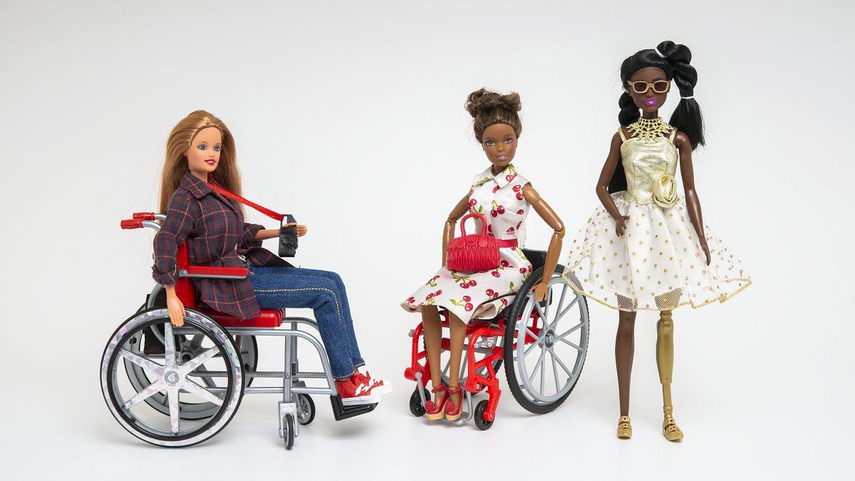 Photo of three dolls, two of them on the wheelchairs.