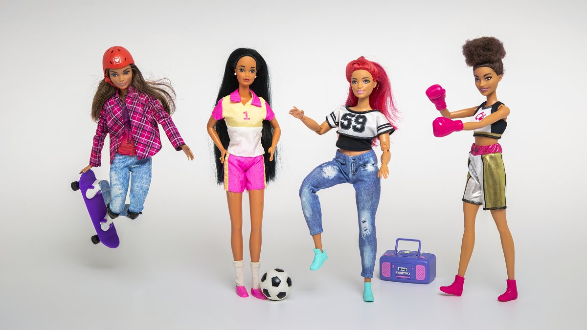 Photo of four dolls, one of them with a skateboard.