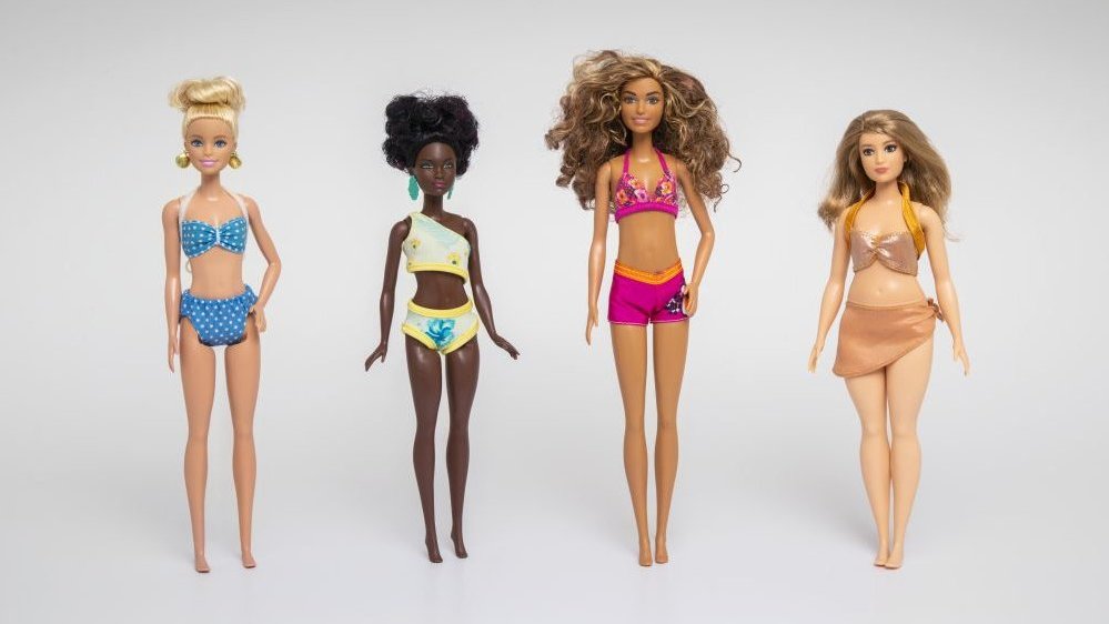 Photo of four Barbie dolls dressed in bikinis.