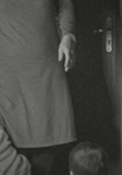 Black and white photo of a part of person in dress.