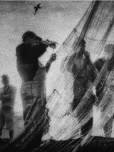 One of the exhibition works - black and white photo of fishermen standing by their fishing nets
