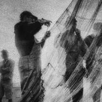One of the exhibition works - black and white photo of fishermen standing by their fishing nets