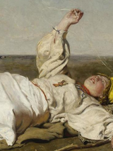 One of the pictures from the exhibition: a person in white garment lying on a ground and looking at the sky.