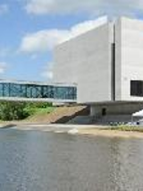 Photo of Porta Posnania - a concrete building by the river