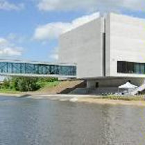 Photo of Porta Posnania - a concrete building by the river
