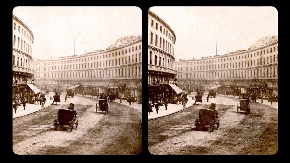 Sterephotograph of a London street: a few hackneys driving along the street and people walking on the both sides of the street. Two buildings on the both sides of the street.