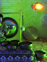 Photo of a woman playing gongs.