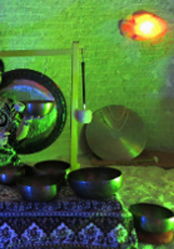 Photo of a woman playing gongs.