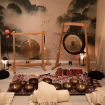 Photo from the place, where the concerts take place: cosy room with two gongs in wooden frames.