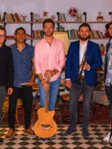 Picture of the band - ritmo afinado's five members, three of them are holding their musical instruments.