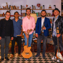 Picture of the band - ritmo afinado's five members, three of them are holding their musical instruments.