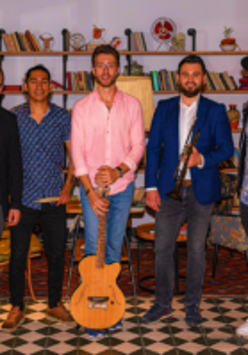 Picture of the band - ritmo afinado's five members, three of them are holding their musical instruments.
