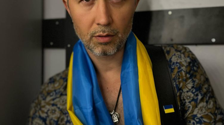 Photo of Sergiy Babkin with the Ukrainian flag around his neck.