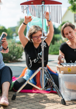 Photo of three women playing musical instruments.