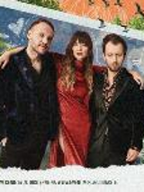 A picture of one woman and two men on the dark red background. A woman in the middle puts her arms around two men