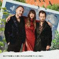 A picture of one woman and two men on the dark red background. A woman in the middle puts her arms around two men