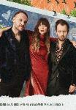 A picture of one woman and two men on the dark red background. A woman in the middle puts her arms around two men