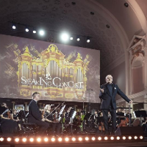 Photo of the orchestra performing on stage of AMU Auditorium