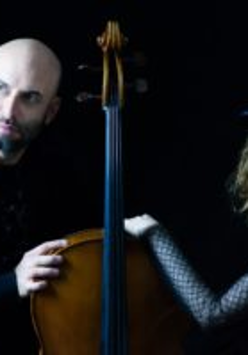 Photo of a man, a woman and a double bass between them.