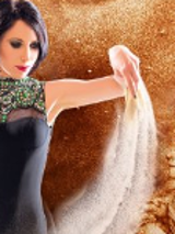 A picture presenting a woman spilling sand