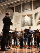 People with laptops on a stage