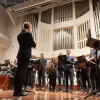 People with laptops on a stage