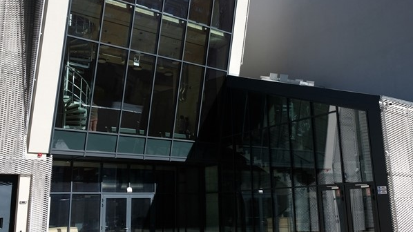 Coloured photo of a modern building - the entrance to the building and two glass walls