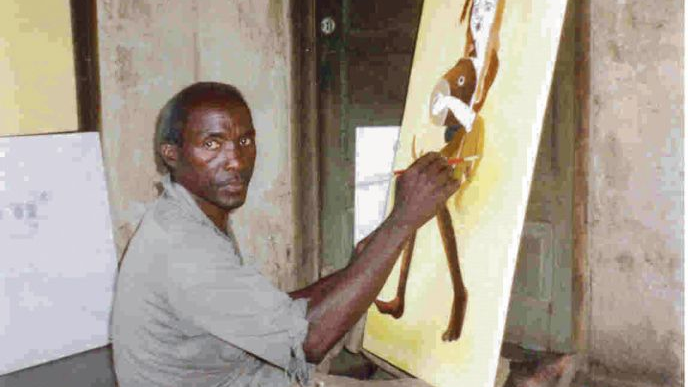 Picture of a painter sitting on the floor and painting a picture of a woman in yellow and brown colours.
