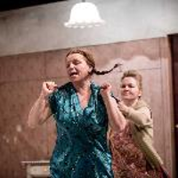 Photo from the performance: two women on stage