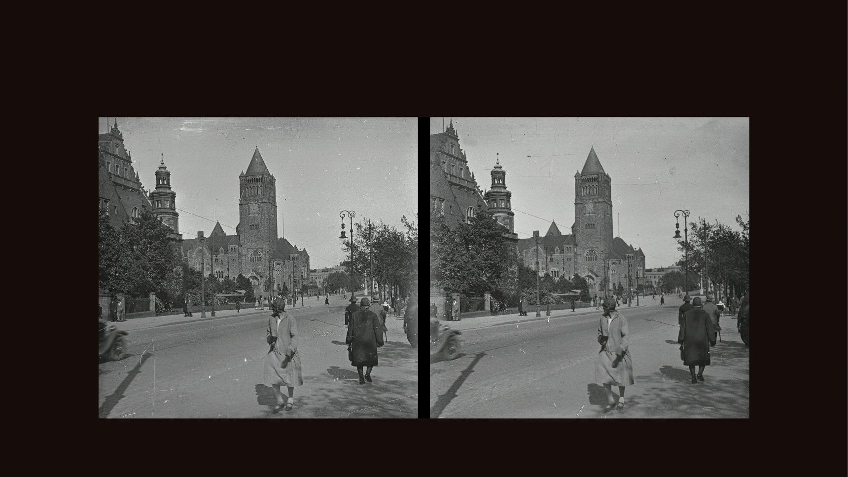 Black and white stereophotograph of the street and people walking along it. Buildings and a few trees as a background.