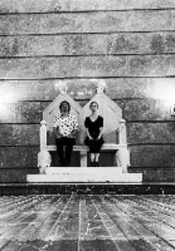 Black and white picture of two musicians sitting on the imperial throne in ZAMEK Culture Centre