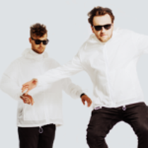 Photo of two men in white hoodies, black trousers and black sun-glasses with their arms outspread on white background