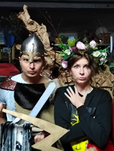 Dwóch mężczyzn i dwie kobiety w przebraniach teatralych. Mężczyźni mają stroje wojowników, a kobiety wieńce i peleryny.