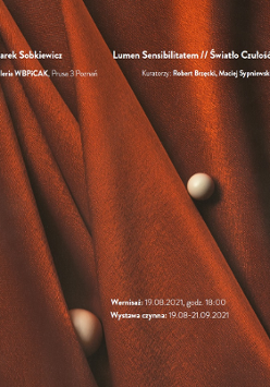 Dwie brązowe kulki na bordowym nieregularnie ułożonym materiale.