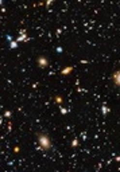 Zdjęcie przedstawia widok kosmosu z teleskopu Hubble'a. Różnobarwne gwiazdy świecą na ciemnym tle.