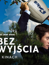 Kolorowy plakat. Mężczyzna w marynarce unosi nad głową doniczkę, którą zaraz ciśnie o ziemię. W tle niebo.