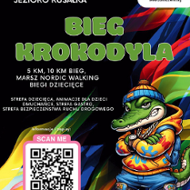 Plakat, który promuje Bieg Krokodyla, na głównym planie rysunek krokodyla w bluzie z kapturem, w czapce i plecakiem. Za nim kolorowe tło i napisy, które informują w wydarzeniu.