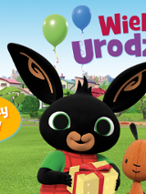 Grafika z czarnym króliczkiem Bingiem i jego przyjacielem misiem. W tle zielona łąka z placem zabaw i domy.