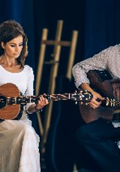 Dominika Żukowska i Andrzej Korycki na scenie. Muzycy grają na gitarach.