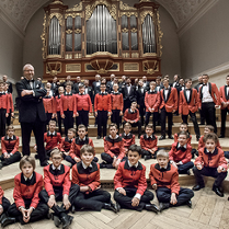 Baner ze zdjęciem członków chóru.