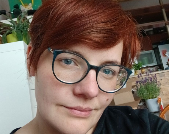 Kobieta w krótkiej fryzurze i okularach.