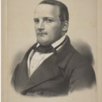 Obrazek przedstawia Stanisława Moniuszkę czyli niskiego mężczyznę z krótkimi włosami.