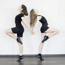 Obrazek przedstawia dwie dziewczyny które są zwrócone do siebie plecami.