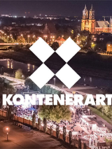 Wieczór. Zdjęcie z góry na KontenerART. Na srodku 4 białe kwadraty stykajace sie narożnikami. W środku tworza kwadrat. Pod spodem biały napis "Kontenerart".