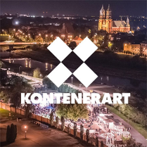 Wieczór. Zdjęcie z góry na KontenerART. Na srodku 4 białe kwadraty stykajace sie narożnikami. W środku tworza kwadrat. Pod spodem biały napis "Kontenerart".