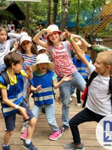 zdjecie rozesmianych dzieci na drewnianym placu zabaw