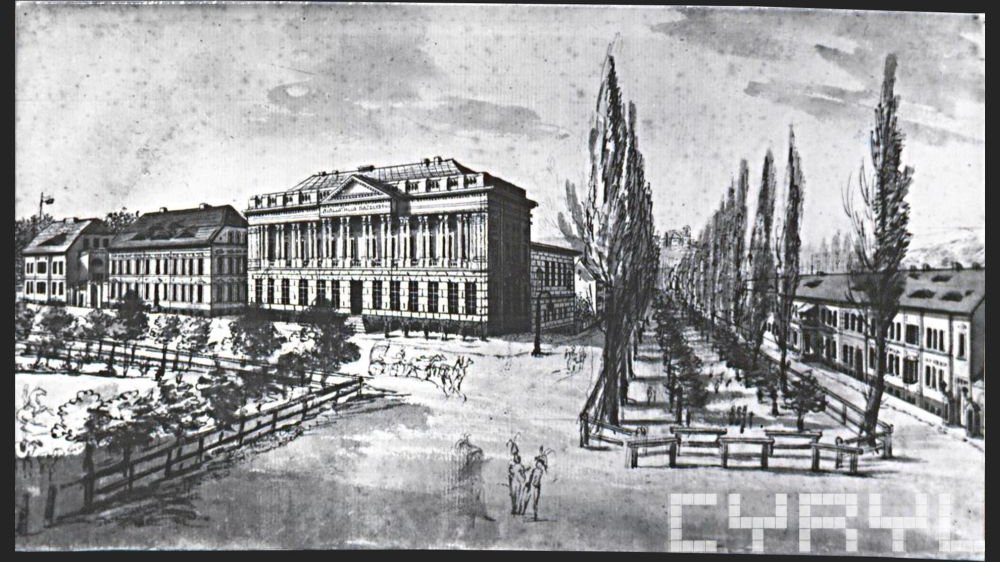 Czarno-biała rycina przedstawiająca gmach biblioteki i otaczający ją plac, na którym rosną drzewa.