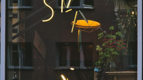 Żółty neon z przechylonym kursywą słowem "Start".